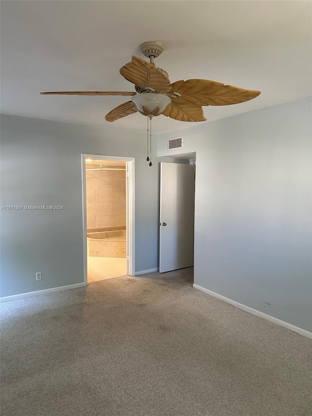 carpeted spare room with ceiling fan