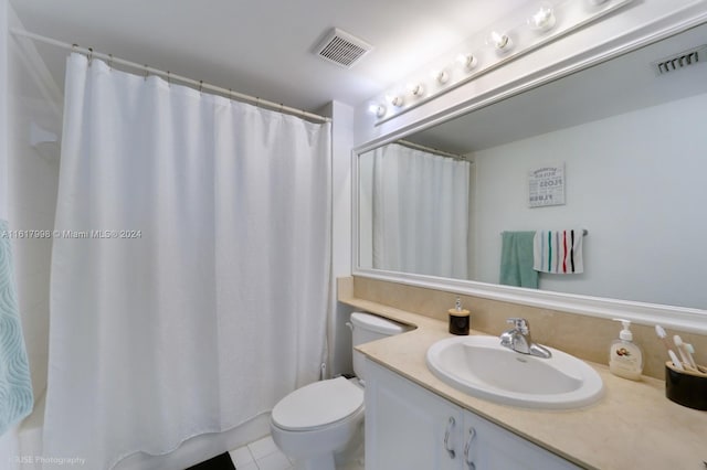 bathroom featuring tile patterned floors, vanity, and toilet