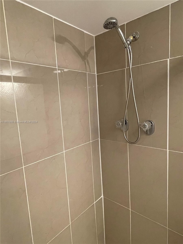 interior details featuring a tile shower