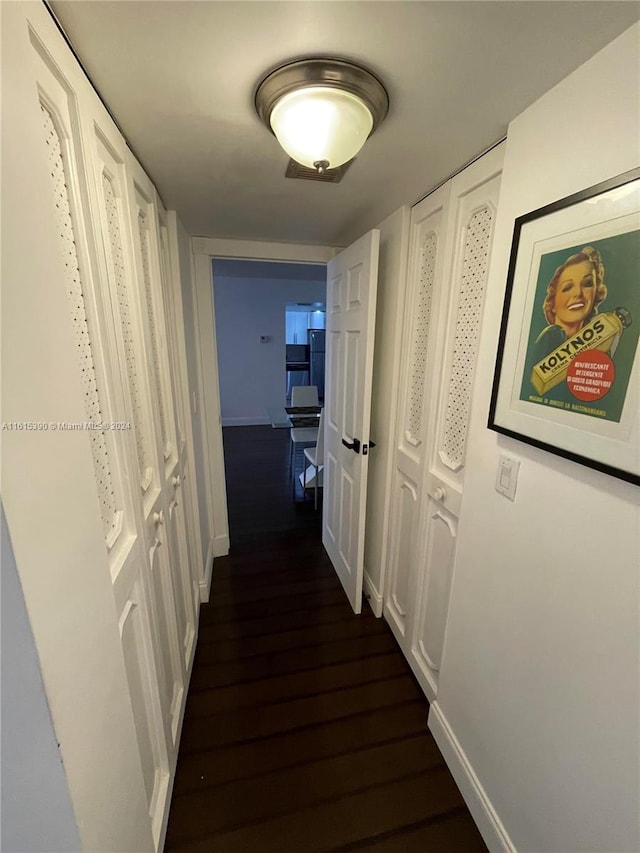 hallway featuring dark hardwood / wood-style flooring