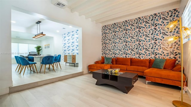 living room with beam ceiling and light hardwood / wood-style flooring