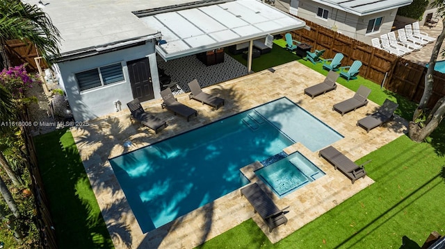 view of pool with a patio and a yard