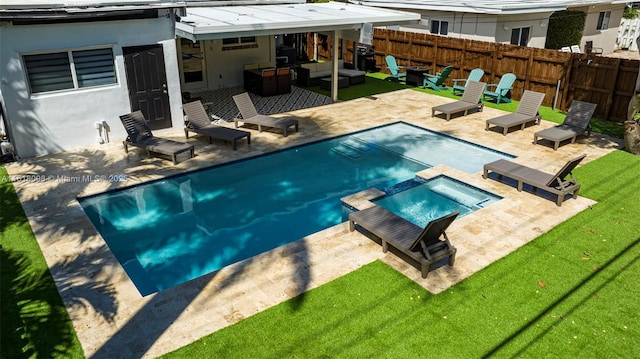 view of swimming pool featuring an outdoor living space, a yard, a patio, and an in ground hot tub