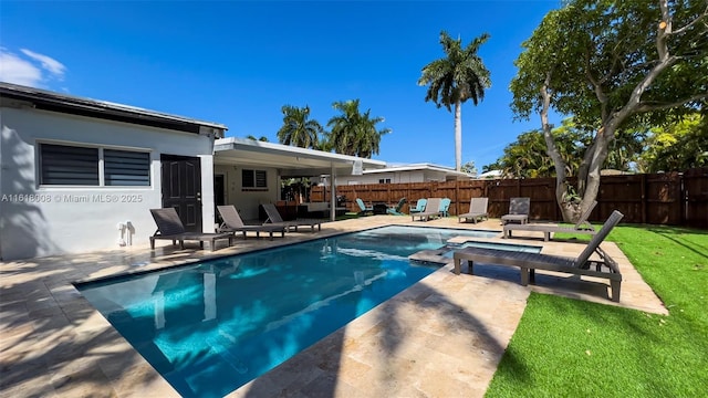 view of swimming pool with a yard and a patio area