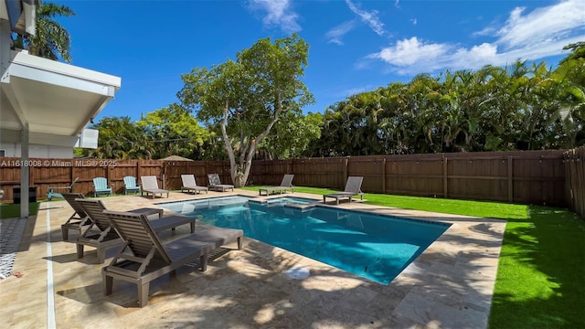 view of swimming pool featuring an in ground hot tub, a patio, and a lawn