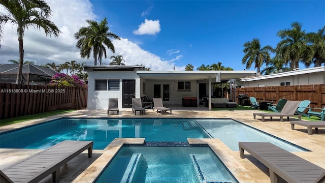 rear view of house with an outdoor hangout area, a pool with hot tub, and a patio