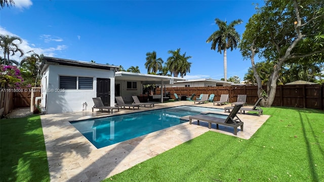 view of swimming pool with a yard and a patio