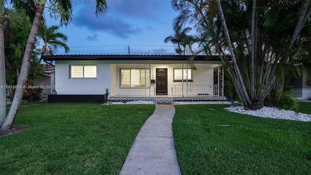 view of front of house with a front yard and covered porch