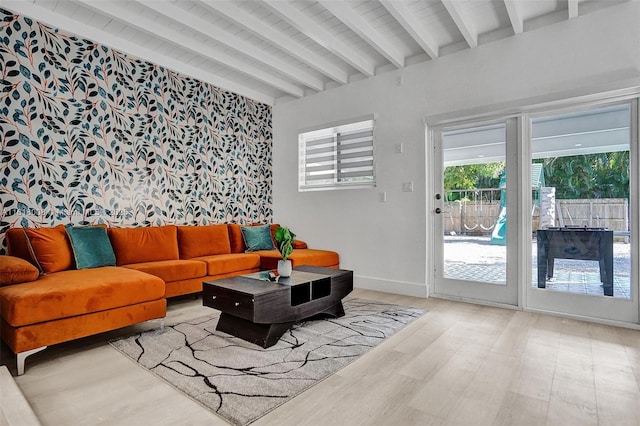 living room with beam ceiling and light hardwood / wood-style flooring