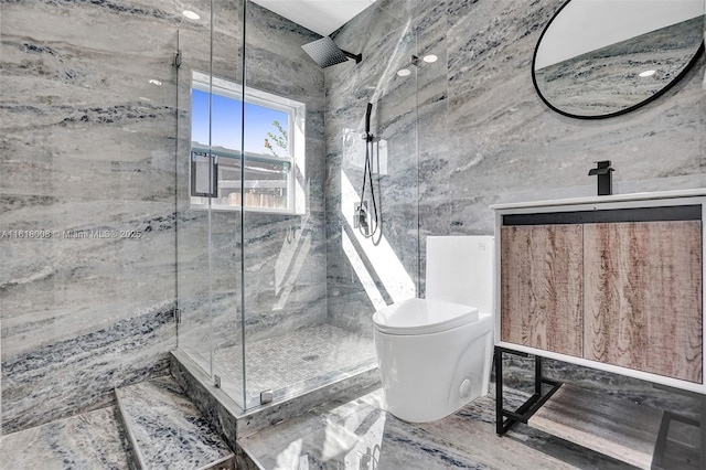 bathroom featuring vanity, toilet, a shower with shower door, and tile walls