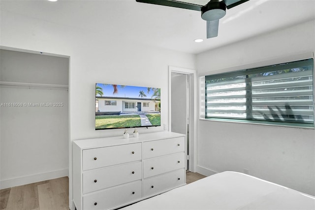 bedroom with ceiling fan and light hardwood / wood-style flooring