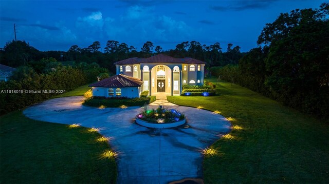 mediterranean / spanish-style home featuring a lawn