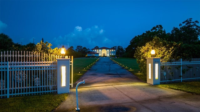 view of gate featuring a yard