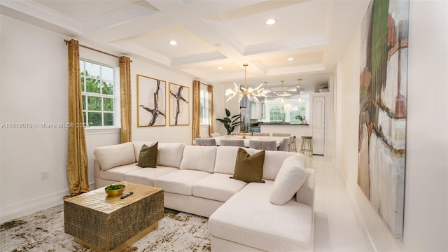 living room with beamed ceiling, ornamental molding, an inviting chandelier, coffered ceiling, and light tile patterned floors