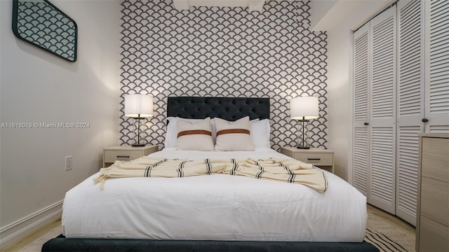 bedroom featuring light hardwood / wood-style flooring and a closet