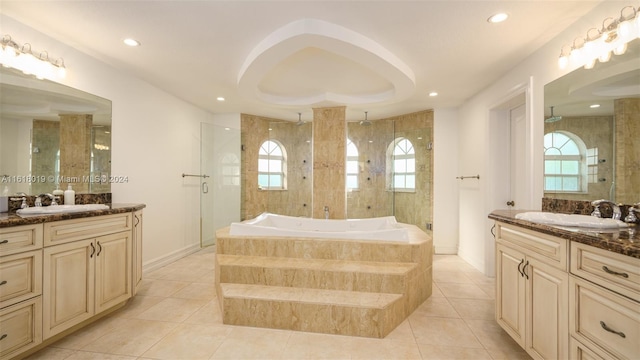 bathroom featuring tile patterned floors, plenty of natural light, plus walk in shower, and vanity