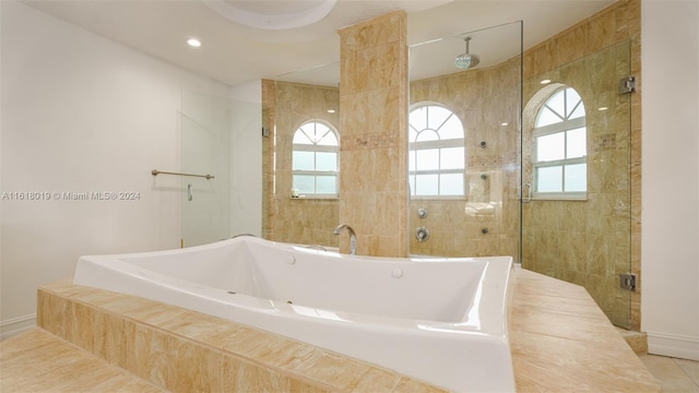 bathroom with independent shower and bath and tile patterned flooring