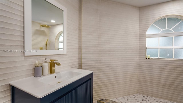 bathroom featuring tile walls and vanity