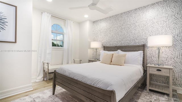 bedroom with wood-type flooring and ceiling fan