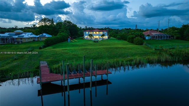 dock area with a water view and a yard