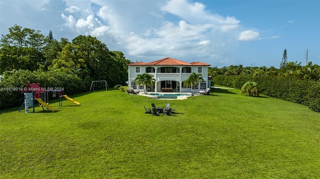 view of yard with a balcony and a playground