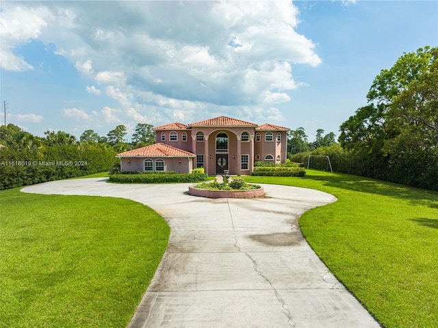 mediterranean / spanish-style house with a front lawn