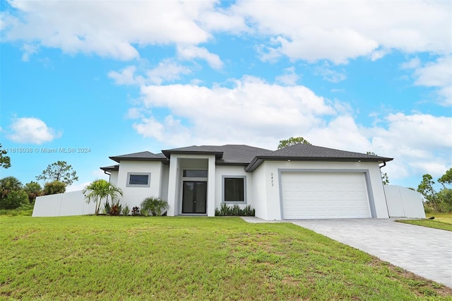 view of front of home featuring a garage and a front lawn