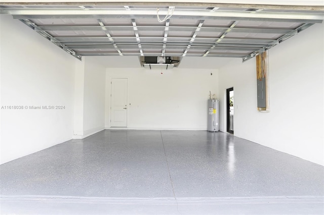 garage featuring a garage door opener, electric panel, and electric water heater