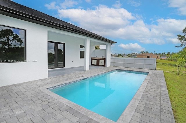 view of pool with a patio area and an outdoor kitchen