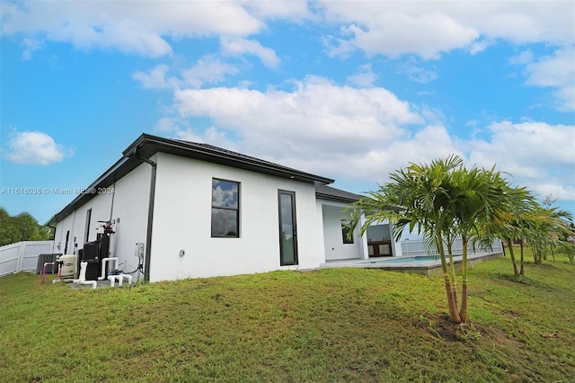 rear view of property with a yard