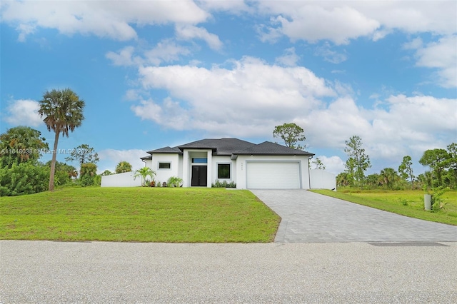 view of front facade with a garage and a front lawn