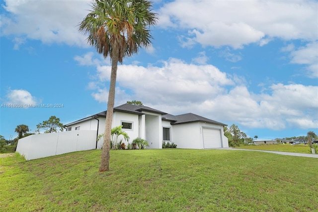 view of front of home with a garage and a front yard