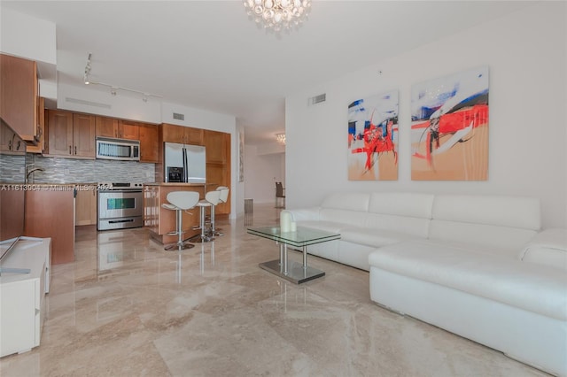 living room featuring sink and an inviting chandelier