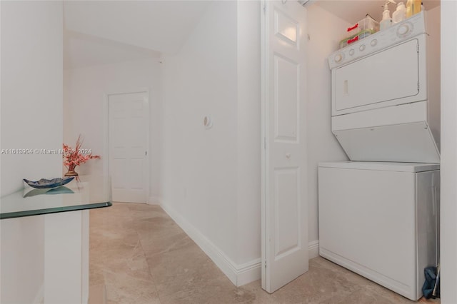 laundry area with stacked washer / dryer