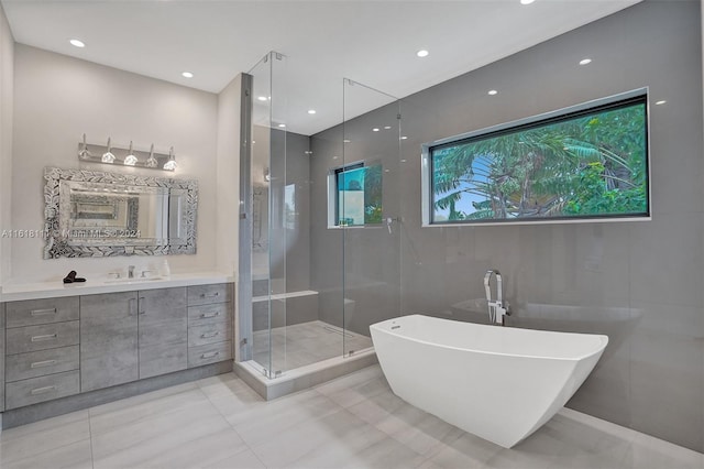 bathroom with plus walk in shower, vanity, and tile patterned floors