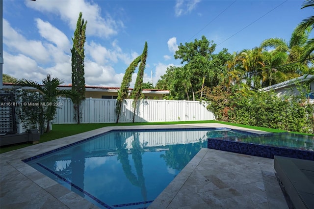 view of swimming pool with a patio area