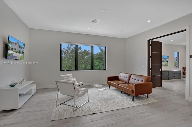 living room featuring light hardwood / wood-style floors and ornamental molding