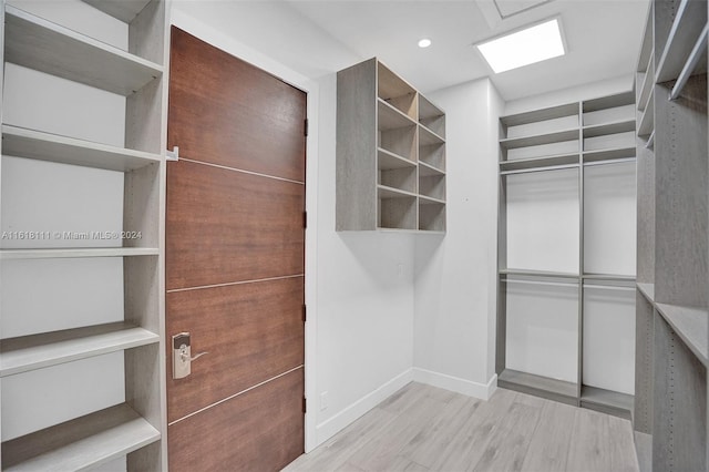 spacious closet featuring light hardwood / wood-style flooring