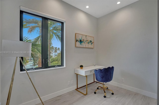 office space with light hardwood / wood-style floors and a wealth of natural light