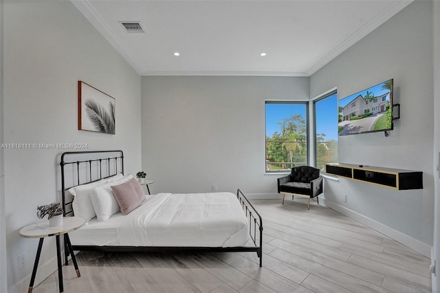 bedroom featuring light wood-type flooring and ornamental molding