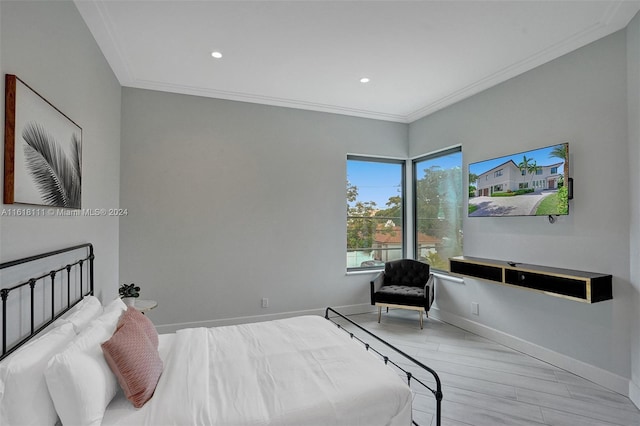 bedroom with crown molding and light hardwood / wood-style floors