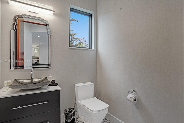 bathroom with toilet and vanity