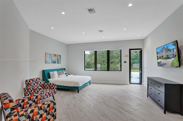 bedroom with light hardwood / wood-style floors and access to outside