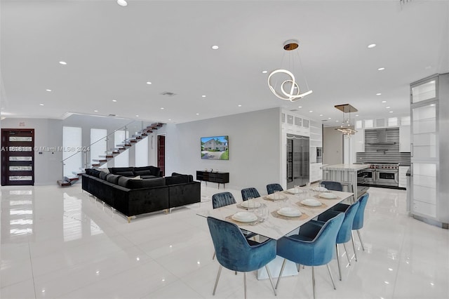 tiled dining room with a notable chandelier