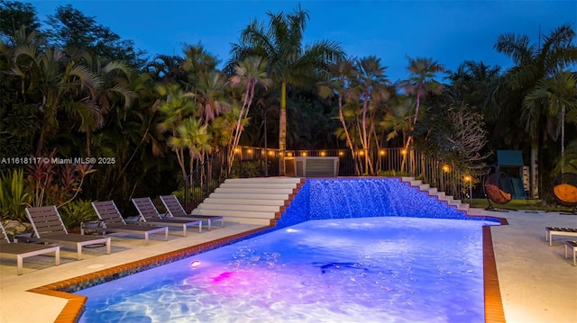 view of swimming pool with a patio area, a hot tub, and pool water feature