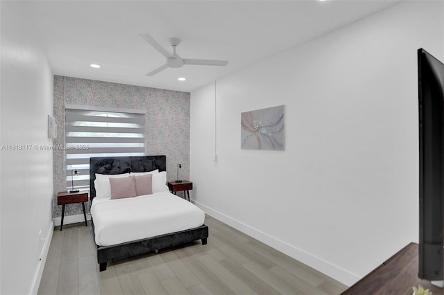 bedroom with hardwood / wood-style floors and ceiling fan