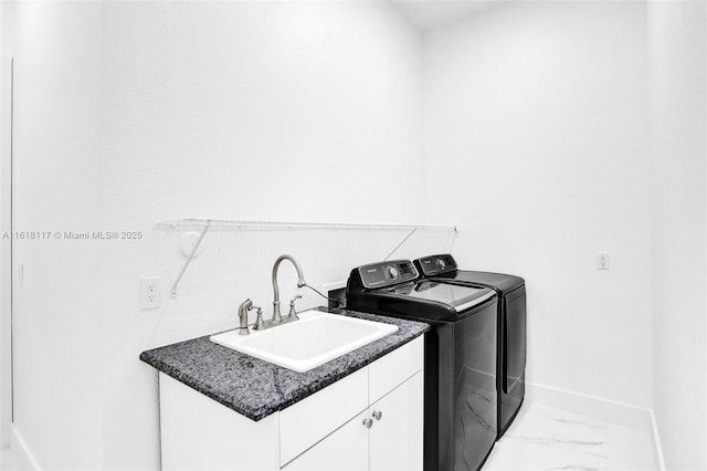 laundry room featuring cabinets, sink, and independent washer and dryer