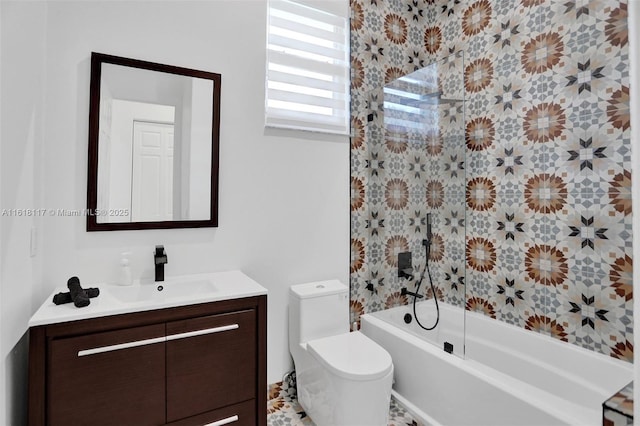 full bathroom featuring vanity, tiled shower / bath combo, and toilet