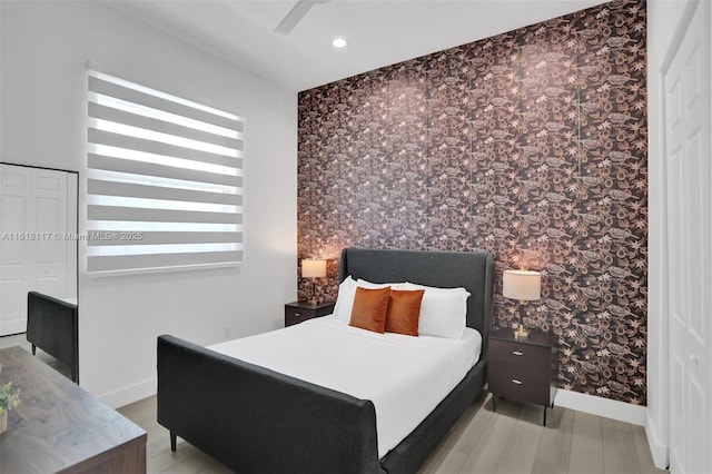 bedroom featuring light hardwood / wood-style floors and ceiling fan