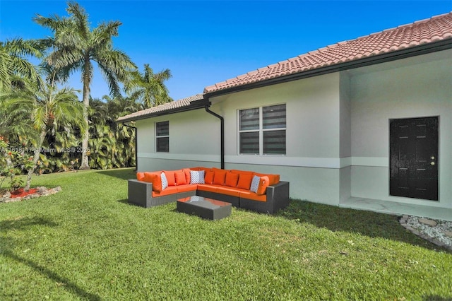 rear view of house featuring an outdoor living space and a lawn